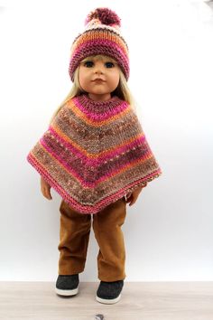 a doll is wearing a knitted ponchy