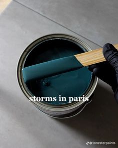 a person holding a paint can with the words storm in paris on it