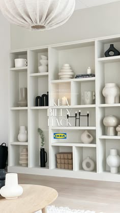 a living room filled with lots of white shelves