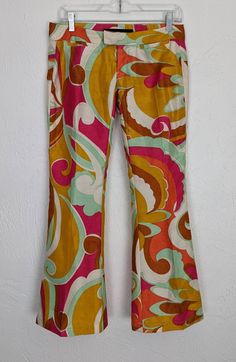 "✰ Rare Miss Sixty Pucci Style  ✰ Polyester material gives good structure. No stretch ✰ Sassy bell cropped capris would look great with some platforms ✰ 2 front coin pockets and 2 back faux pockets Circa: 2000s Material: 100% polyester Label: Miss Sixty, made in Italy - MEASUREMENTS- (measurements taken flat) please refer to listing images for how we measure Label size: 25 Waist: 15\" (please note that these are low-rise and sit closer to the hip bones and not the true waist) Hip: 18.5 Length: 3 Retro Stretch Bottoms For Spring, Retro Spring Stretch Bottoms, Groovy Flare Stretch Bottoms, Groovy Fitted Bottoms For Spring, Groovy High Waist Fitted Bottoms, Groovy Fitted Wide Leg Bottoms, Groovy Wide Leg Spring Bottoms, Groovy Wide Leg Bottoms For Spring, Spring Groovy Wide Leg Bottoms