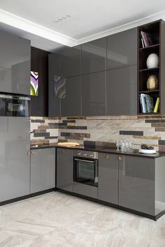 a kitchen with gray cabinets and marble counter tops