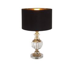 a lamp with a black shade on it and a gold trimming around the base