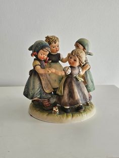 a group of figurines sitting on top of a white table next to each other