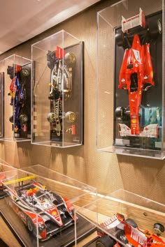 a display case filled with different types of race cars on wooden shelves next to each other