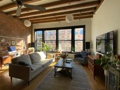 a living room filled with furniture and windows