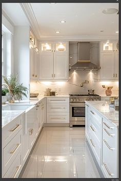 a large kitchen with white cabinets and marble counter tops, along with stainless steel appliances