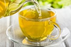 tea being poured into a glass cup