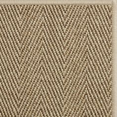 a close up view of a brown and tan area rug with an interesting pattern on it