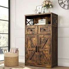 an old wooden cabinet with doors and drawers in a living room next to a clock