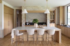 a kitchen with an island and bar stools