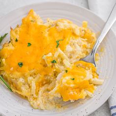 a white plate topped with an omelet covered in cheese