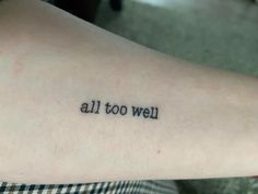 a person with a tattoo on their arm that says, all too we'll