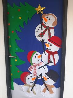 a door decorated with snowmen and a christmas tree