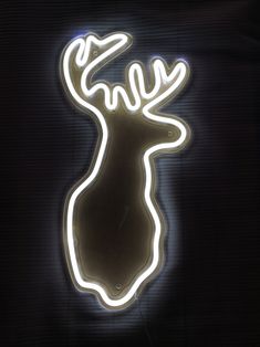 a neon sign with a deer's head on it