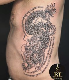 a man with a dragon tattoo on his stomach is shown in black and grey ink