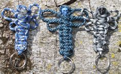 three blue and silver crocheted key chains on a rock