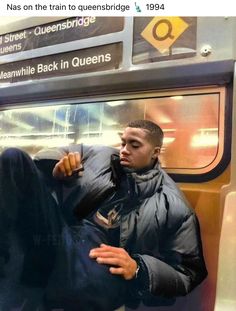 a man sitting on a subway train with his foot propped up against the back in queen's park