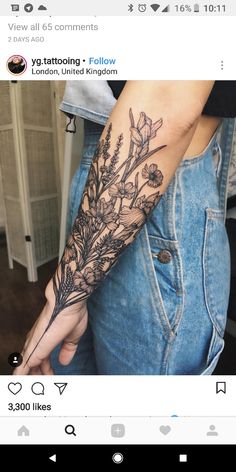 a woman's arm with flowers and leaves tattooed on the left side of her arm