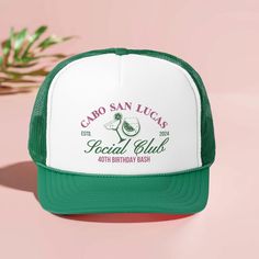 a green and white trucker hat with the words cado san lucas social club on it