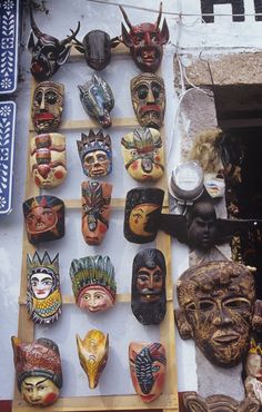 many masks are on display in front of a store