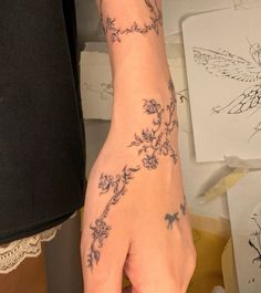 a woman's hand with tattoos on it