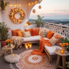 an outdoor seating area with candles, pillows and blankets on the balcony overlooking the city