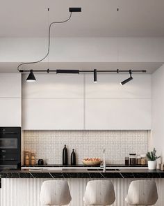 three stools sit in front of a kitchen counter