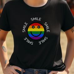 Rainbow Smiley Tee - a vibrant fusion of joy and style! This unisex ultra cotton tee is not just a piece of clothing; it's a statement of happiness and inclusivity. Adorned with a radiant, rainbow-colored smiley face encircled by the uplifting word 'SMILE', this tee is designed to spread cheer and positivity wherever you go. Crafted for comfort and durability, our tee boasts a classic fit that suits everyone. The taped shoulders ensure a flattering upper-body fit, while the absence of side seams presents a sleek, uninterrupted flow. Each shirt is made from 100% US cotton, promising both long-lasting comfort and steadfast style. The medium fabric weight (6.0 oz/yd² (203 g/m makes it an excellent choice for all seasons. Designed to blend seamlessly into both casual and semi-formal settings, Pre-shrunk Crew Neck Shirt For Pride, Pre-shrunk Cotton Rainbow T-shirt, Cotton T-shirt With Rainbow Print For Pride, Funny Multicolor Short Sleeve T-shirt, Fun Multicolor Pre-shrunk T-shirt, Funny Multicolor Pre-shrunk T-shirt, Trendy Multicolor Pride T-shirt, Trendy Rainbow Pride T-shirt, Trendy Rainbow T-shirt For Pride