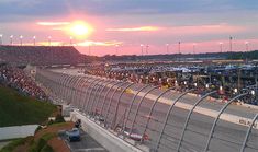 the sun is setting at the starting line of a nascar racing track in daytona beach, florida