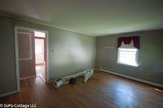 an empty room with hard wood flooring and no one in the room looking at it