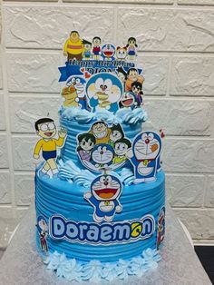 a blue cake with cartoon characters on it