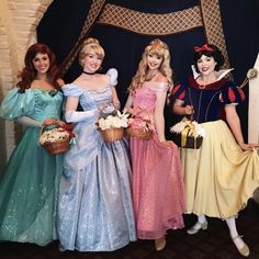 there are four women dressed up as disney characters