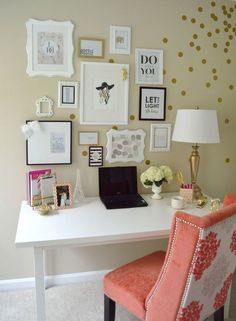 a white desk topped with a laptop computer sitting next to a wall covered in pictures