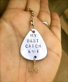 a hand holding a keychain that says, my best catch is love