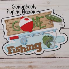 the scrapbook paper memories gone fishing is displayed on a white wooden background with text