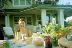 a woman sitting at a table with food in front of her