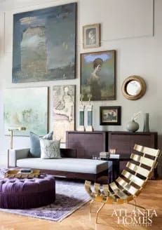 a living room filled with furniture and pictures on the wall