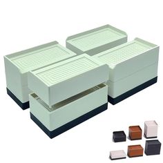 four white boxes with black and brown lids