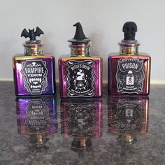 three flask bottles sitting on top of a counter