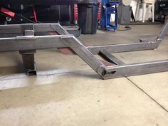 a metal frame sitting on the ground in a garage