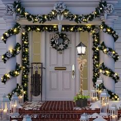 a front door decorated with christmas lights and wreaths