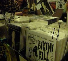 people are looking at records on display in a store