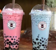 two bubble teas are sitting next to each other