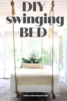 a white bed sitting under a canopy with text overlay that reads diy swinging bed