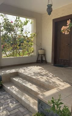 the sun shines through two windows onto a patio with steps leading up to it