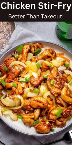 chicken stir fry with onions and green peppers in a skillet on top of a table