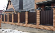 a row of brick houses with black iron fences on the front and back sides, along side each other