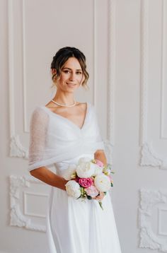 a woman in a white dress holding a bouquet