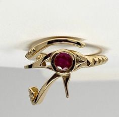 18K gold and Ruby Eye of Ra ring Make a bold statement with this ring that features the eye of Ra a protective symbol said to destroy evil around the wearer in ancient Egyptian culture. Ruby Round Natural Eye-clear Message for pricing in other karats or gemstone customization. Ancient Protection Symbols, Masonic Eye, The Eye Of Ra, Peacock Ring, Ancient Egyptian Symbols, Mens Skull Rings, Eye Of Ra, Oxidized Silver Rings, Lace Ring