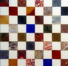 a close up view of a multicolored tile pattern